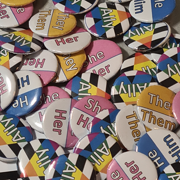 Pronoun pins produced by Forge Valley students with He/Him, She/Her, They/Them and Ally variants