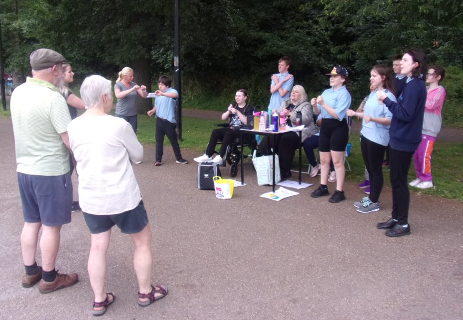 Seven Hills taking part in a sing and sign sponsored walk around Norfolk Park